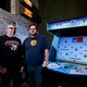 Nikita Mikros (left) and Josh DeBonis (right) with Logan Arcade’s Killer Queen machine